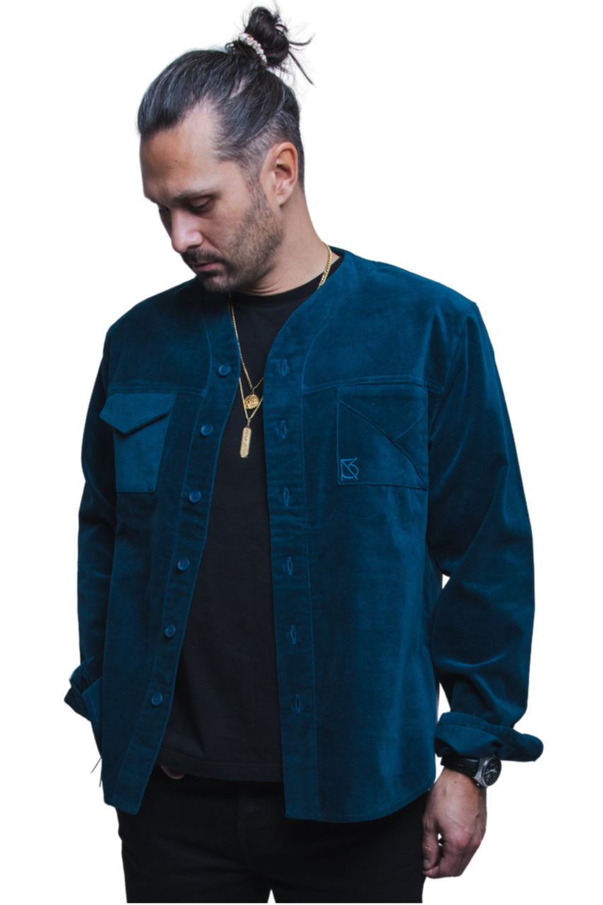 Model wearing the Herman teal corduroy shirt over a black t-shirt