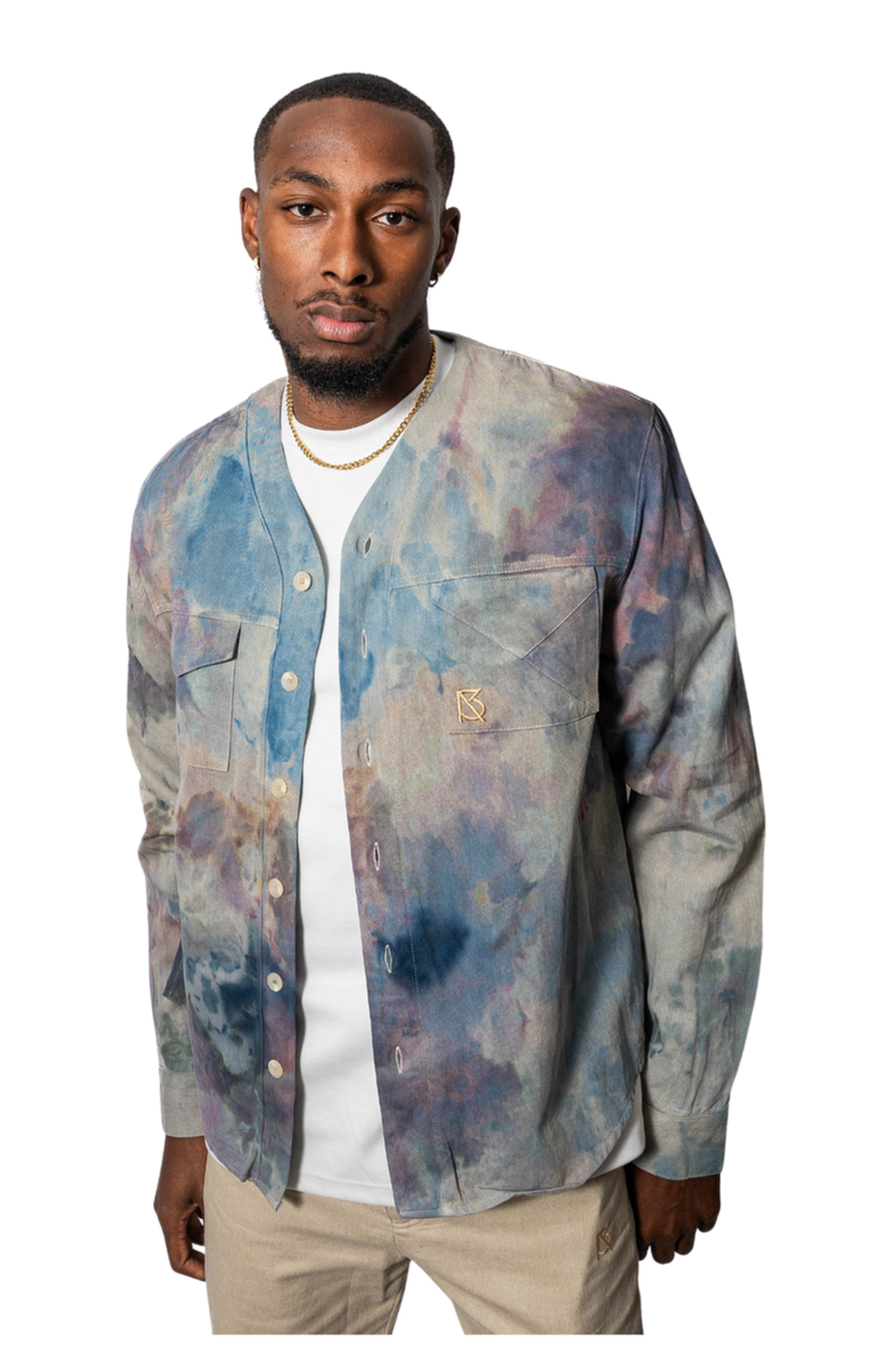 Model wearing a colorful patterned shirt over a white t-shirt 