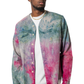 Model wearing a colorful tie-dye shirt over a white t-shirt 